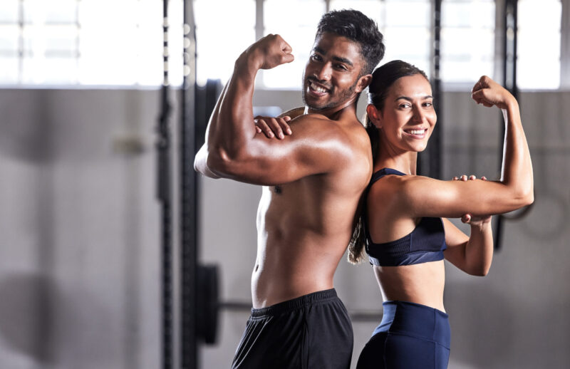 Fitness, flexing muscles and strong couple goals while doing exercise or training in a gym. Portrai.